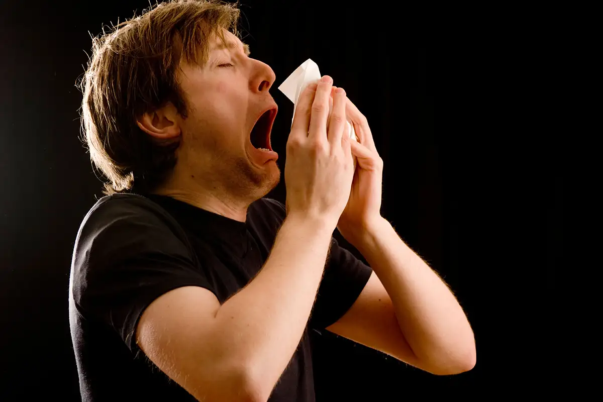 man sneezing