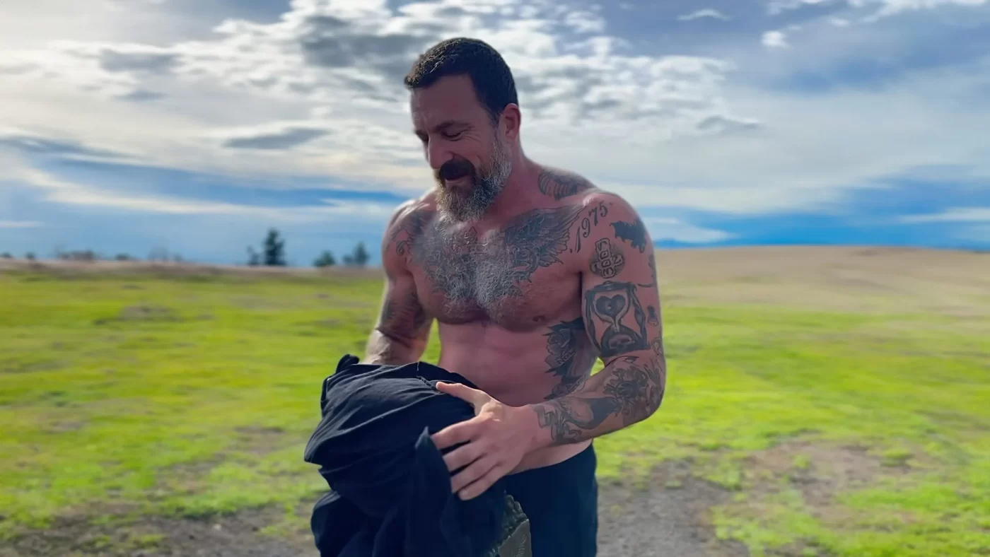 Andrew Huberman shirtless after a workout, showing his tattoos 